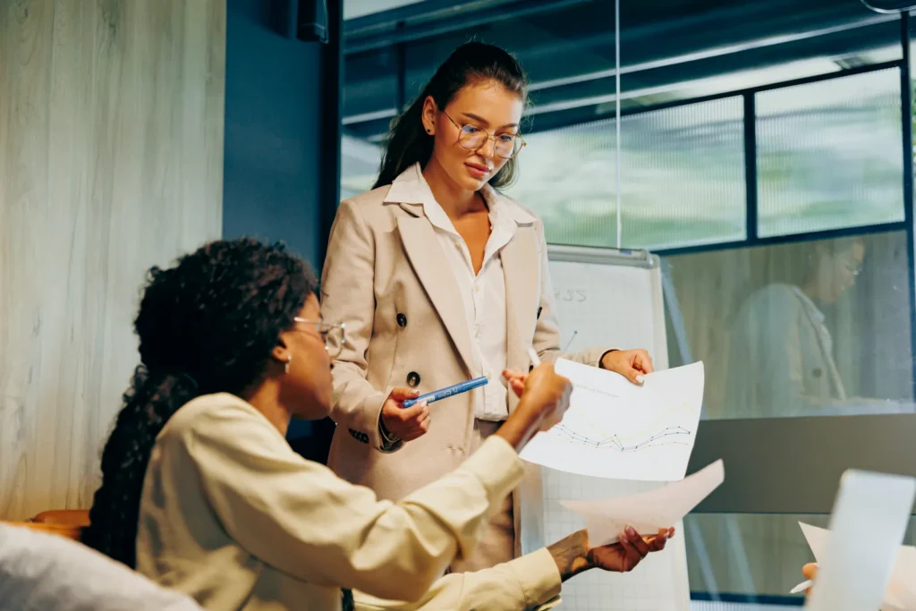 Two business women looking over financial documents